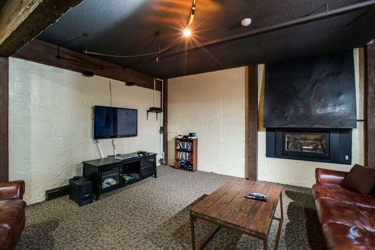 Snowline Lodge entertainment room cozy gas fireplace