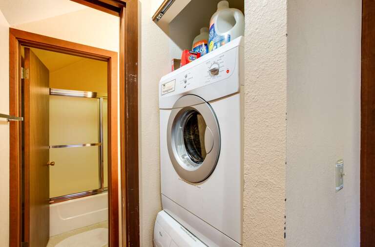 Upstairs hallway looking into bathroom with laundry area