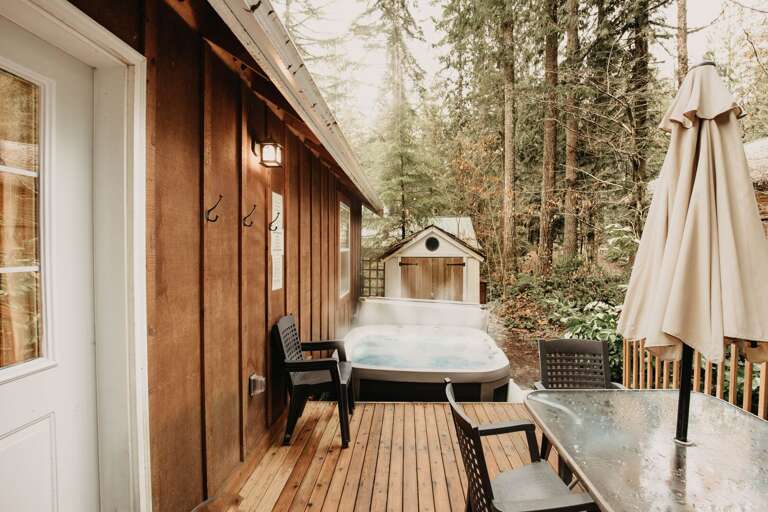 View from master bedroom door of hot tub and deck