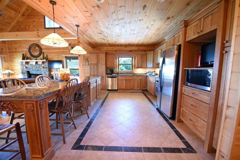 Wood-paneled Kitchen Interior With Island And Appliances
