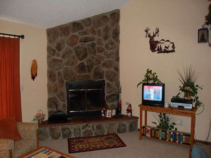 Cozy Living Room With Stone Fireplace And Television Cozy Living Room With Stone Fireplace And Television
