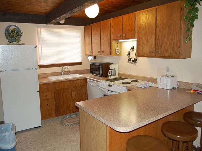 Traditional Kitchen Interior With Wooden Cabinets And Appliances Traditional Kitchen Interior With Wooden Cabinets And Appliances