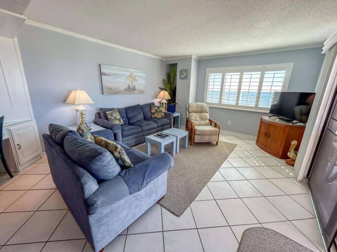 Seaside Sitting Space Sporting Sofas, Soft Shades, And Sunny Scenery