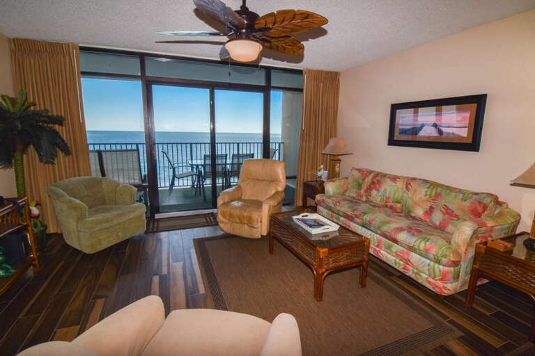Lounge Leading To Ocean View, Furnished With Floral Sofa And Plush Chairs
