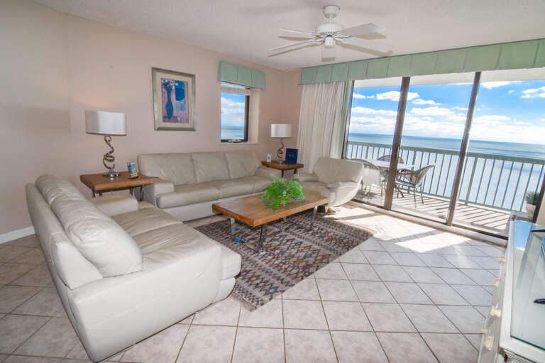 Living Room Leading To Lush, Large Balcony Overlooking The Blue Bay