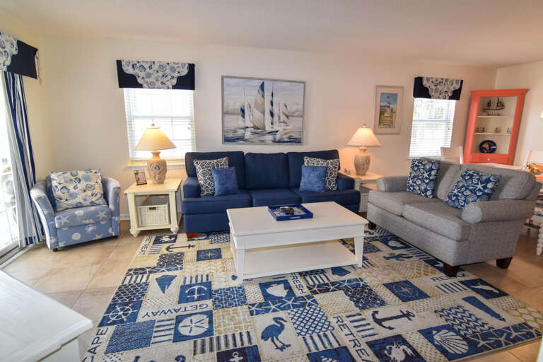 Blue-themed Living Room With Marine Motifs, Matching Sofas And A Nautical Rug