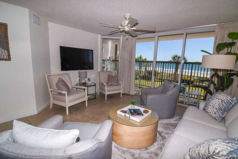 Living Space With Seating Facing Balcony And Beach Beyond