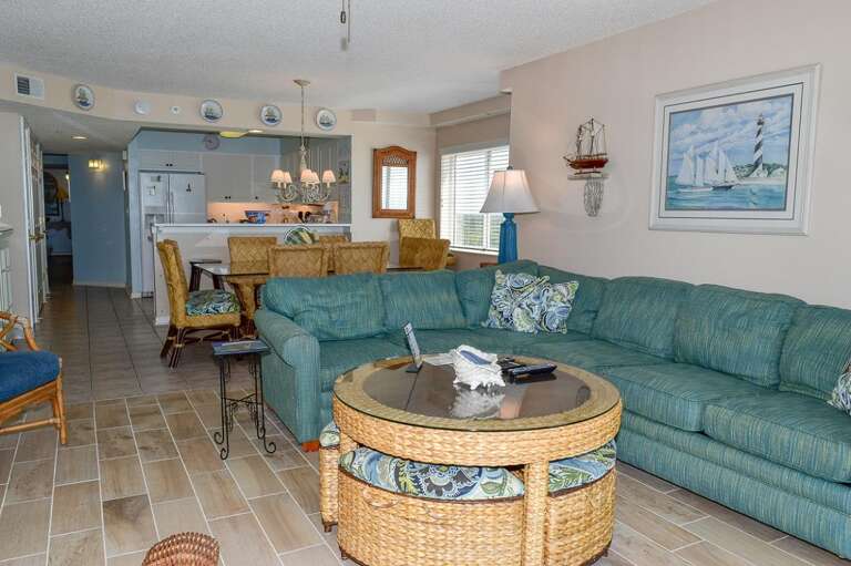Living Room With Sea-green Sofa, Tile Floors, And Maritime Motifs