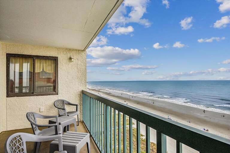 Balcony View Of Beach And Blue Sky From Vacation Rental