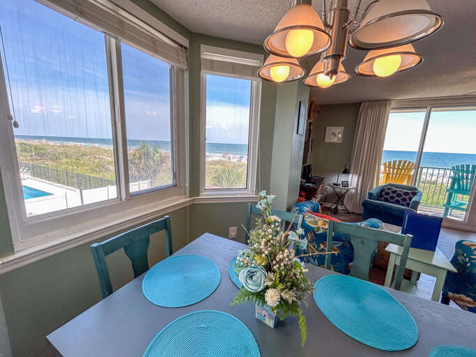 Dining Space With Sea Vistas, Blue Plates, And Airy Ambience