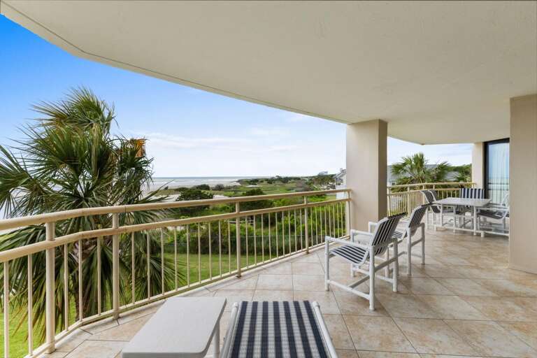 Balcony View Of Beach Beyond, Chairs And Railing, Serene Scene