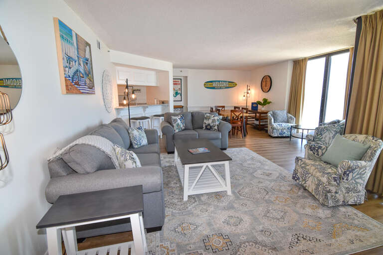 Spacious Living Area With Sofas, Tables, And Ocean View