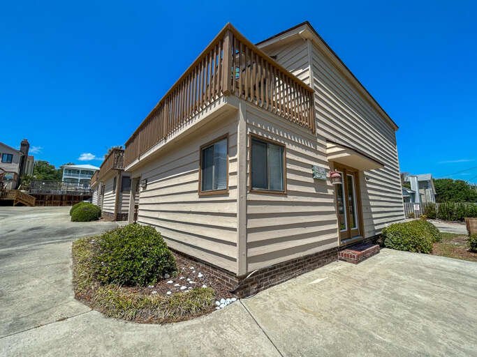 Beige Building Beneath Blue Sky, Balcony Bordered By Balusters