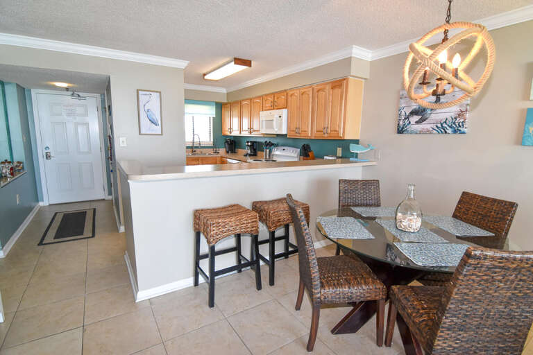 Bright Beachside Breakfast Area With Bar Stools And Pendant Lighting