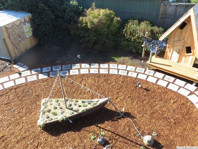 Backyard With A Swing And Wooden Playhouse
