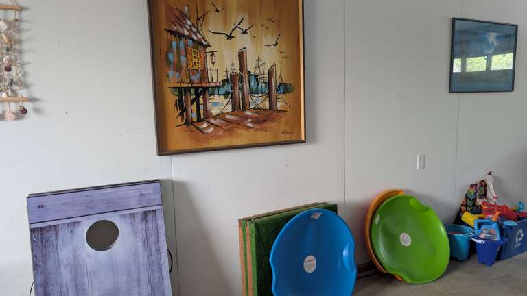 Other games and beach toys in the garage.  Cornhole, sand saucers sand castle building toys