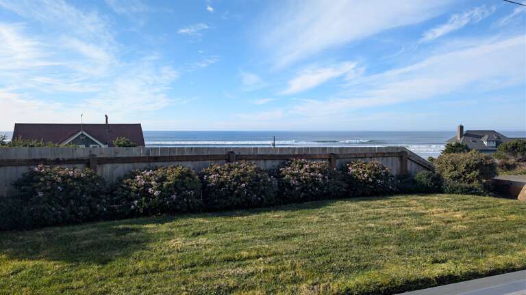 grassy area in front of deck just partially fenced