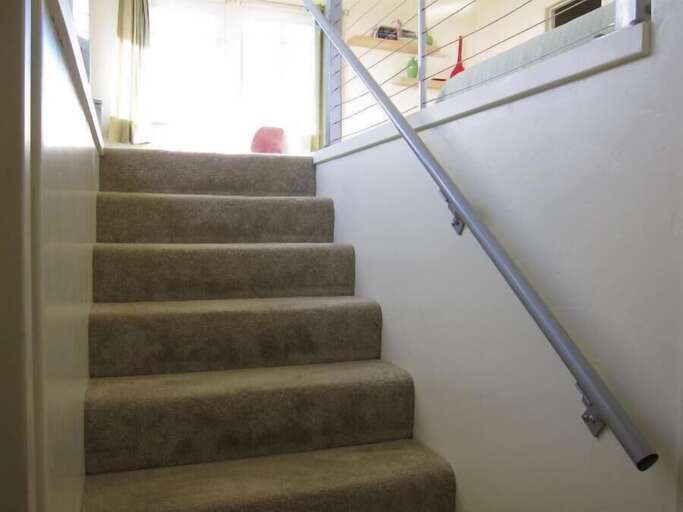 stairs to primary suite with pocket door halfway up