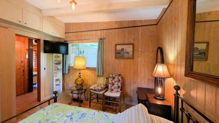 TV and sitting area in queen bedroom