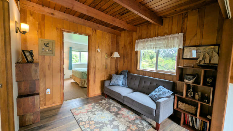 Bonus room with fold flat/click-clack sofa on way to primary bedroom