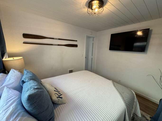 queen bedroom with its own TV