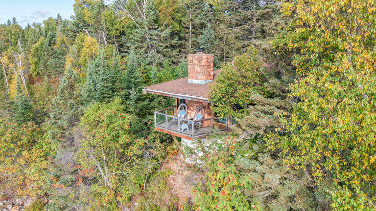 With commanding 180 degree views of Lake Superior, your stay is enhanced with a massive natural stone fireplace combined with a walk-out deck having the big lake serve as your companion. With commanding 180 degree views of Lake Superior, your stay is enhanced with a massive natural stone fireplace combined with a walk-out deck having the big lake serve as your companion.
