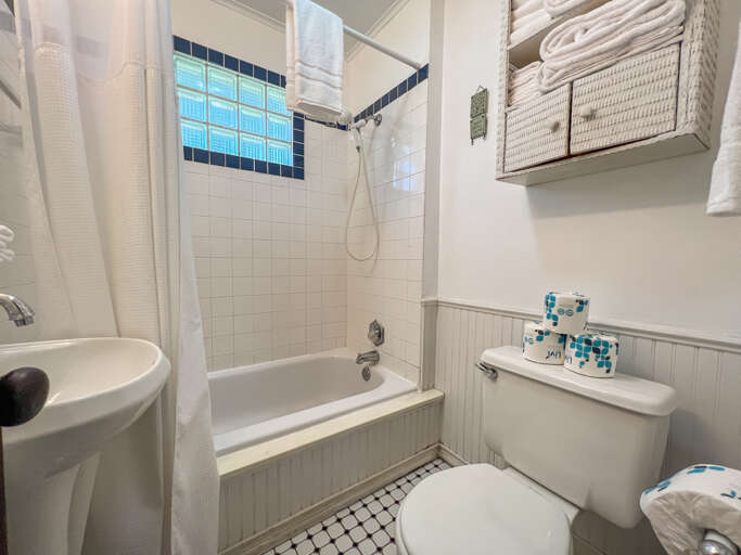 The bathroom features a shower/tub combo.
