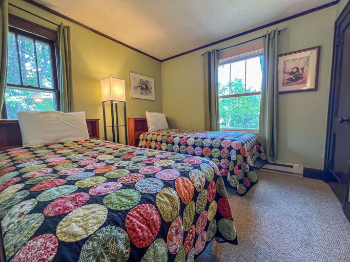 The guest bedroom features two twin beds