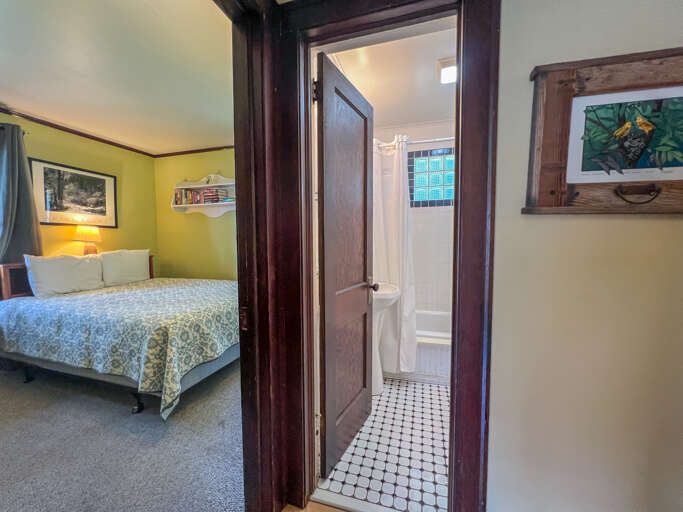 The hallway leads to the bathroom and two bedrooms.