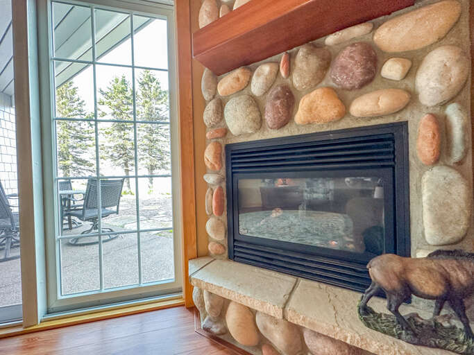 Bedroom 1 has a stone surround gas fireplace.