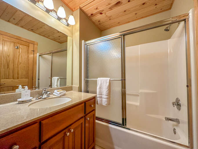 The bathroom has a shower/tub combo. The bathroom has a shower/tub combo.