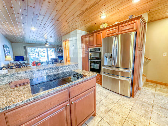 The stainless steel appliances including a stacked oven and microwave.