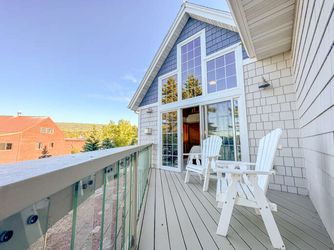 Step out of Bedroom 1 onto the lake-facing balcony.