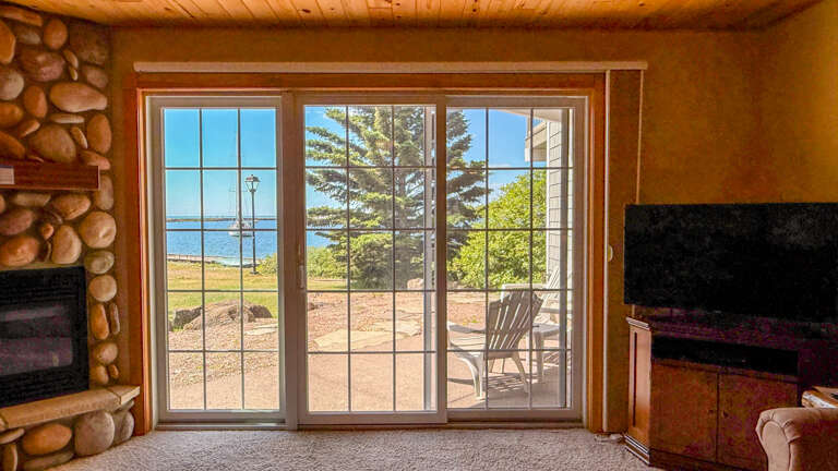 Your lake view retreat awaits, where natural wood warmth meets stunning waterfront scenery. Step through the glass doors to your private patio and let the peaceful shoreline become your daily backdrop.