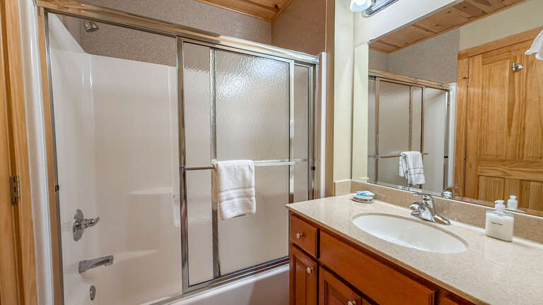 Step into your private bathroom, where fresh towels and a spotless vanity await your arrival. The enclosed shower is perfect for unwinding after a day of adventure.