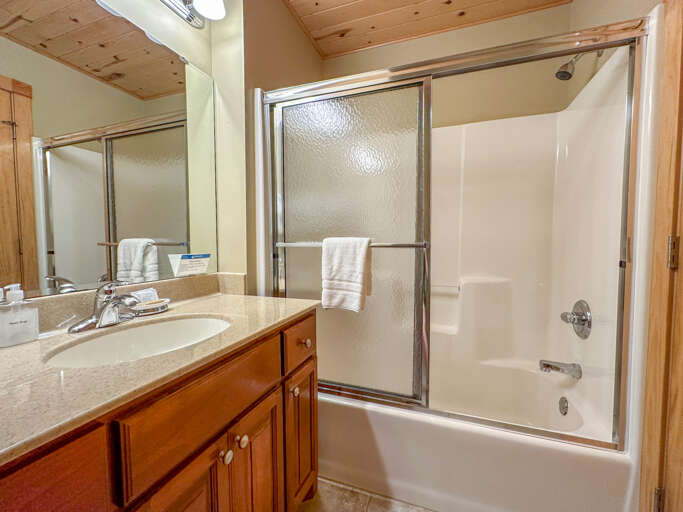 This bathroom also features a shower/tub combo.