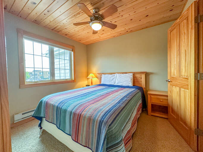 Bedroom 2 is located on the second level and features a queen bed.