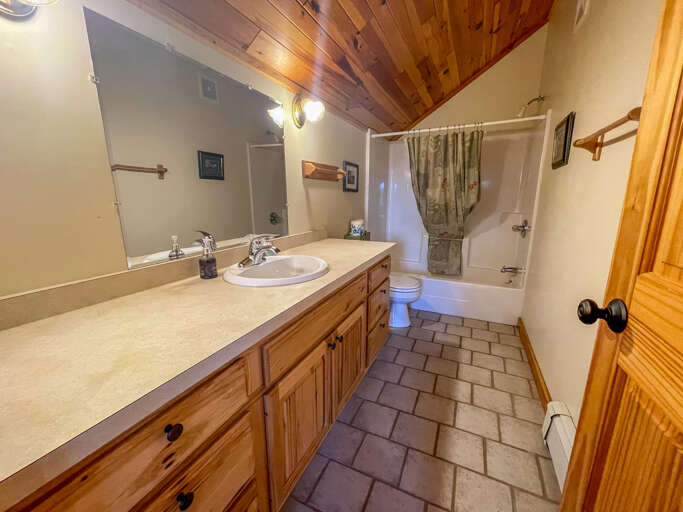 Attached is a master bathroom with a shower/tub combo