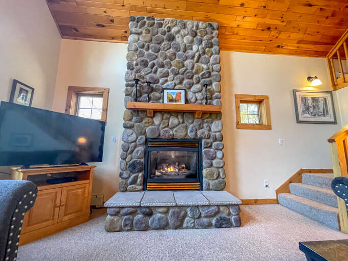 The living room features a floor to ceiling gas fireplace.