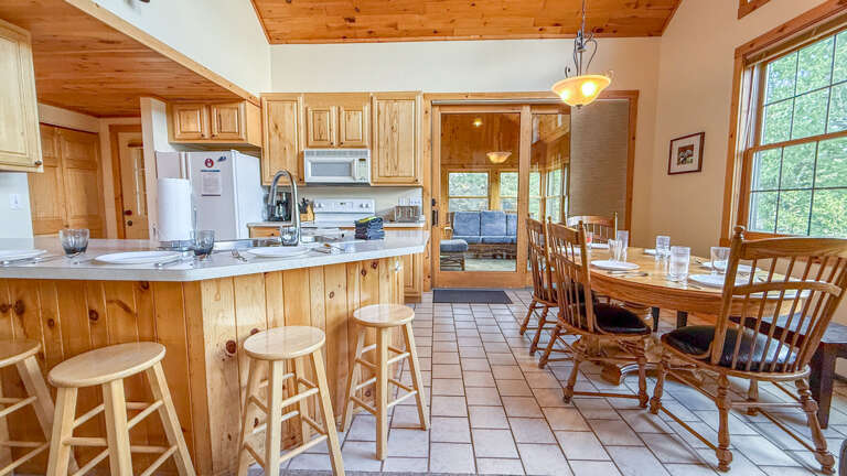 Your spacious open kitchen and dining area welcomes you with warm wood finishes, natural light, and everything you need to gather and create memorable meals together.