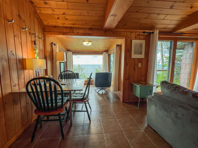 There is a small dining table next to the living room.