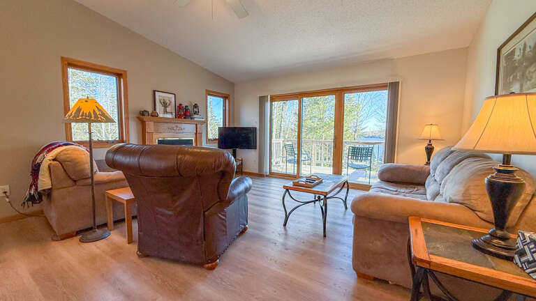 Seating in the living room with access to the lake-facing balcony.