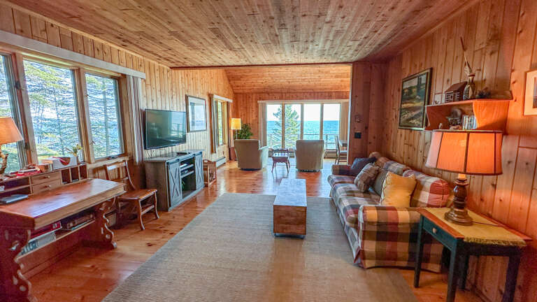 With its combination of wood-paneled walls, hardwood floors, and wood stove it has the feel of a traditional north woods cabin retreat.