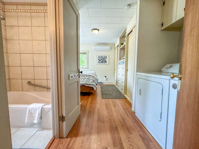 The bedroom, bathroom, and laundry room is located off of the living room.