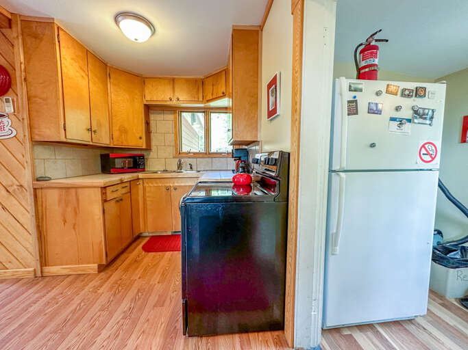 The refrigerator can be found in the back entryway.