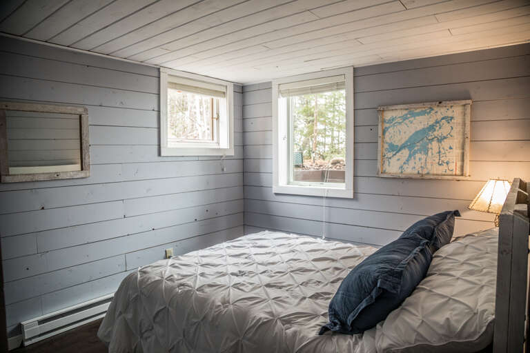 This lower level bedroom features a queen bed.