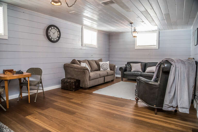 The family room includes a sleeper sofa and an electric fireplace