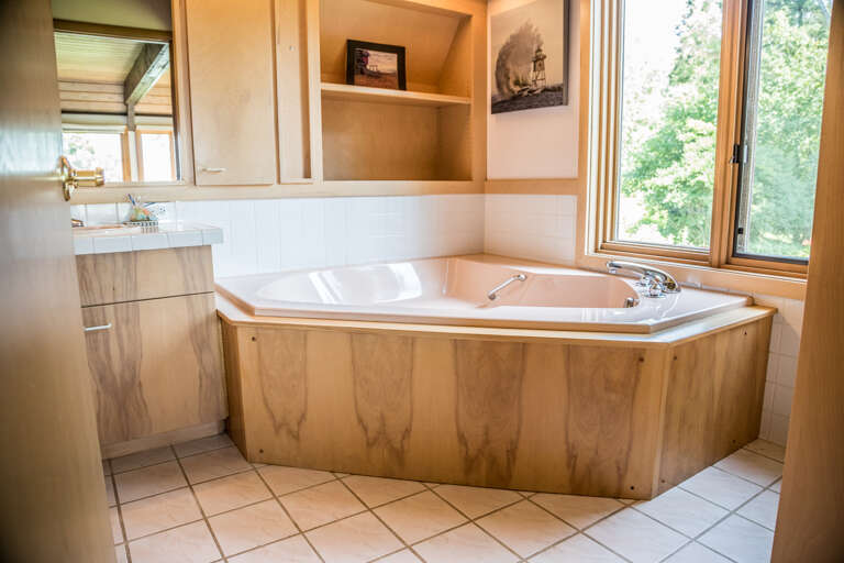 The attached master bathroom has a separate soaker tub.