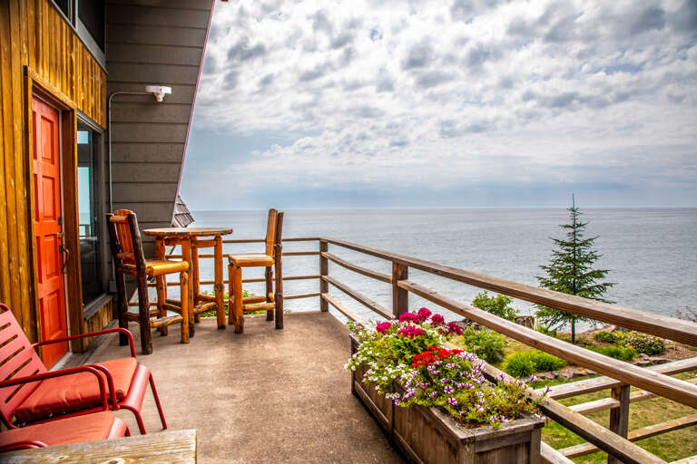 The side deck features more seating as well as a table and chairs.