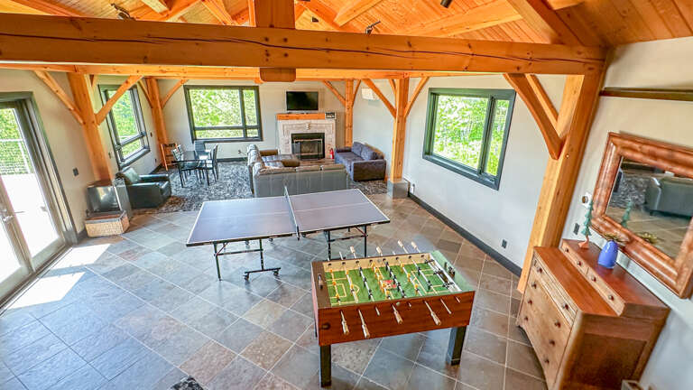 Foosball and Ping Pong tables in the game room area.